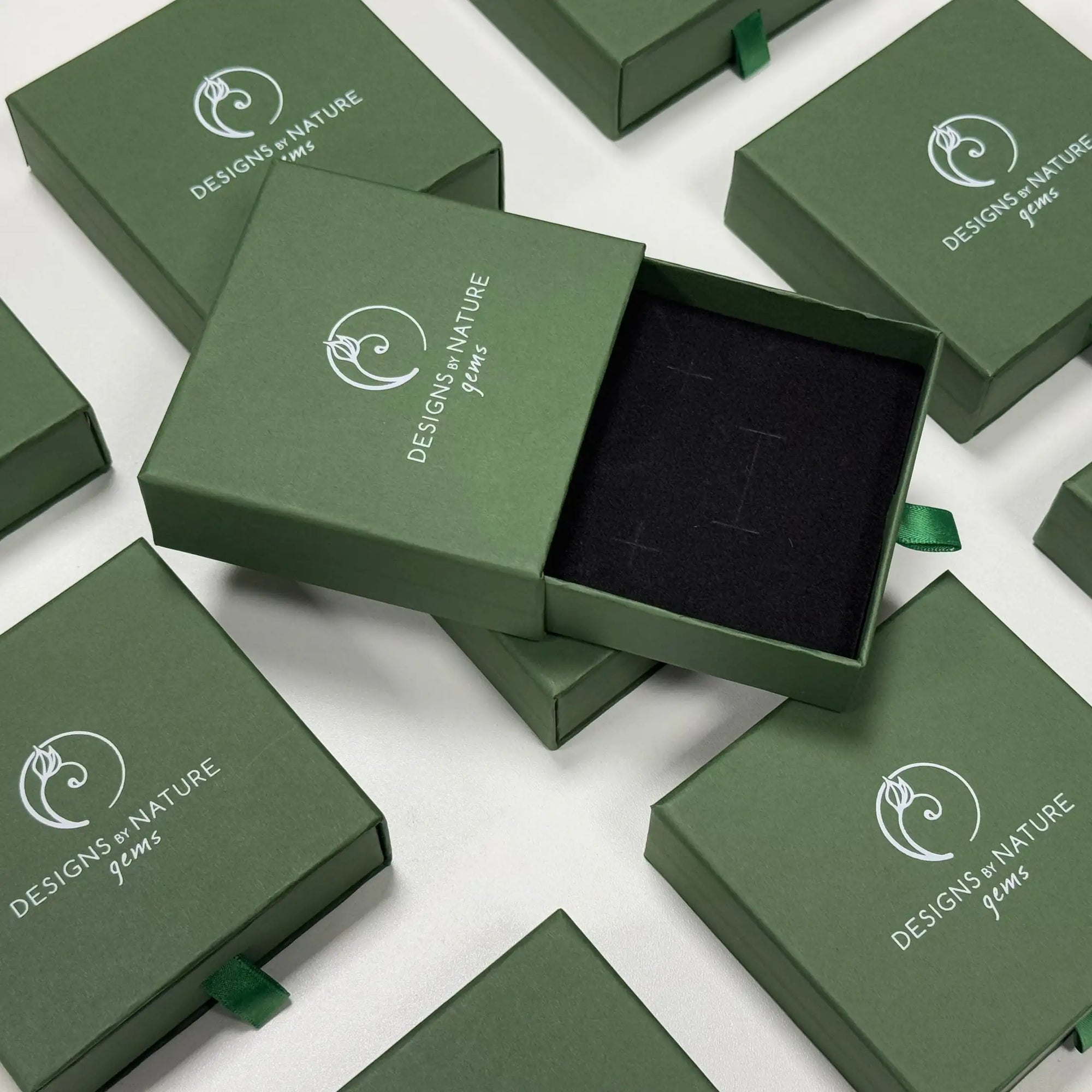 Branded Designs by Nature Gems jewelry box packaging for emerald moon drop earrings in 14k gold filled.