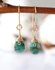 Detailed front view of emerald drop earrings, genuine faceted emerald with minimalist 14k gold filled wire wrapping, Designs by Nature Gems

