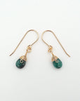 Side angle of emerald drop earrings, minimalist artisan wire wrapping, 14k gold filled
