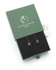 Emerald drop earrings presented in a branded gift box, ready for gifting, with antique bronze copper wire wrapping.