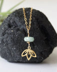 Emerald and lotus necklace for women with natural faceted emerald bead and gold vermeil lotus charm, detailed front view
