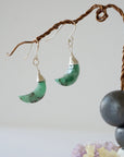 Front view of emerald moon drop earrings in 925 sterling silver with natural faceted crescent moon emeralds.