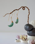 Zoomed out front view of emerald moon drop earrings in 14k gold filled with natural faceted emerald stones.