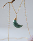Left angle detail of faceted emerald moon necklace for women with classic artisan 14k gold filled wrapping