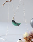 Left angle detail of faceted emerald moon necklace for women with classic artisan 925 sterling silver wrapping