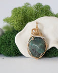Detailed front view of emerald necklace for women with natural polished-raw emerald and handcrafted 14k gold filled and sterling silver wire wrapping