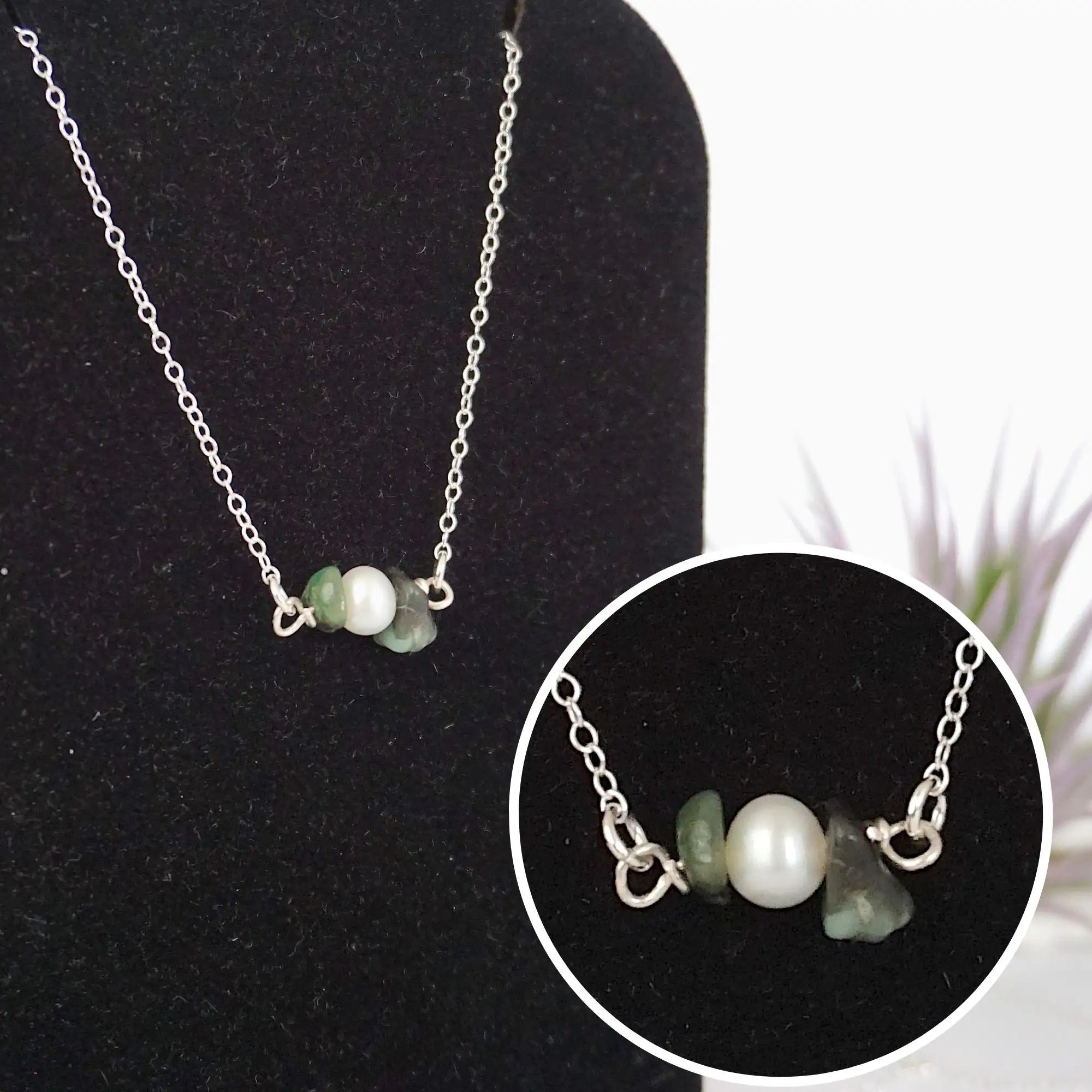 Close-up of raw emerald stones and freshwater pearl bar on 925 sterling silver necklace