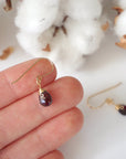 Garnet 14k gold filled drop earrings held in hand for size reference, lightweight wire wrapped gemstone earrings for women