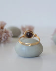 Back view of simple gold wire wrapped garnet ring with clean minimalist band design