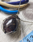 Infographic showing a garnet pendant in the making, handcrafted with care using wire wrapping techniques