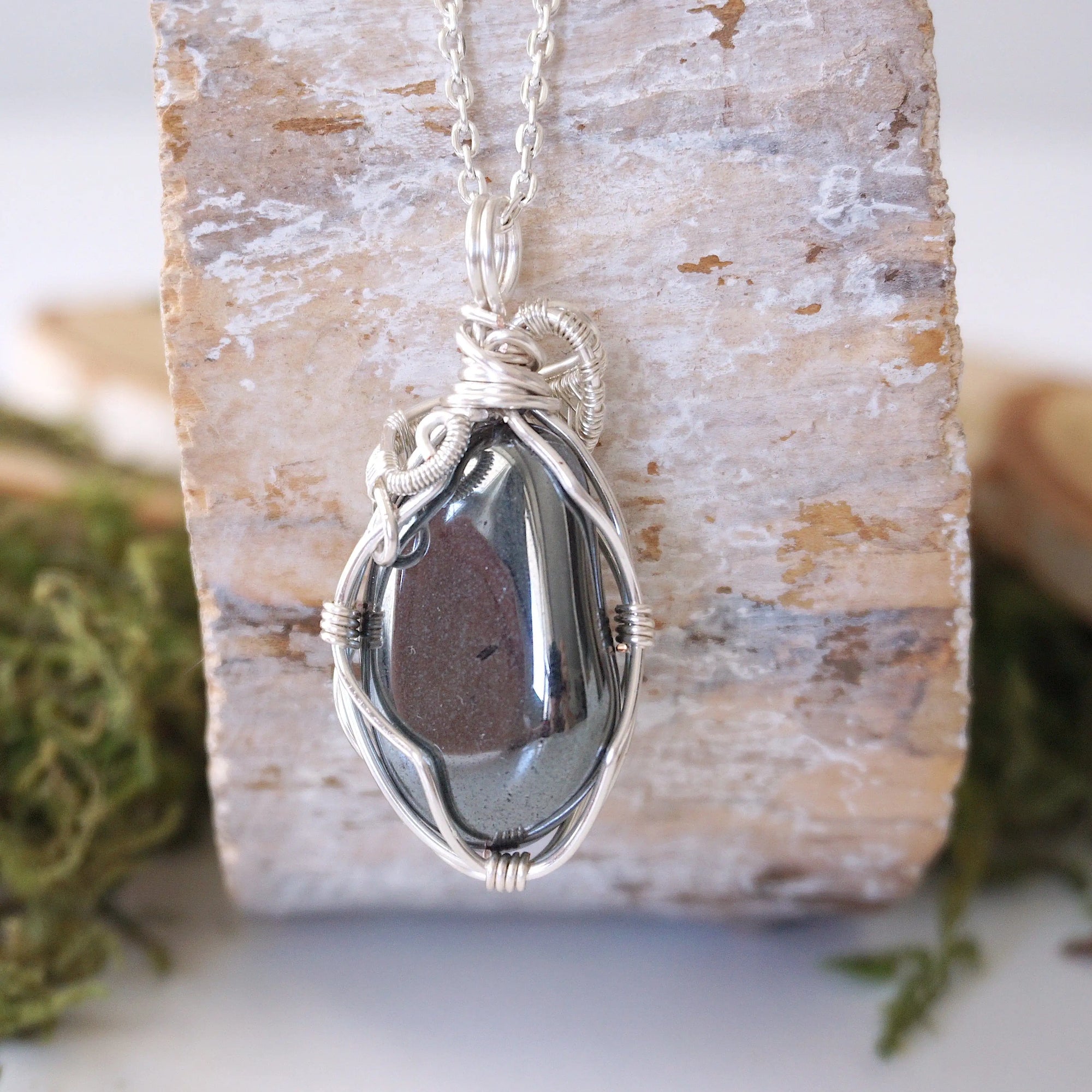 Back view of hematite pendant necklace showing secure handcrafted soft silver over copper wire wrapping