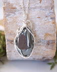 Back view of hematite pendant necklace showing secure handcrafted soft silver over copper wire wrapping