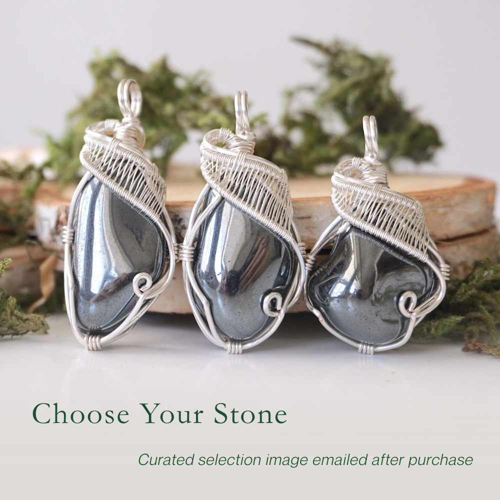 Three natural hematite pendants showing variation in size and shape in handmade wire wrapped jewelry