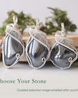 Three natural hematite pendants showing variation in size and shape in handmade wire wrapped jewelry