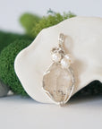 Detailed front view of silver wire wrapped herkimer diamond and freshwater pearl pendant, unique artisan necklace