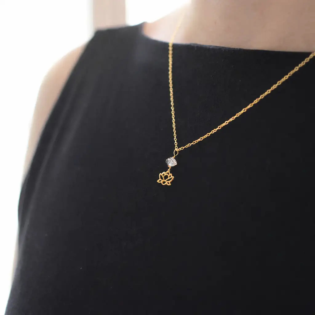 Herkimer diamond and lotus necklace in gold vermeil worn on a female model.