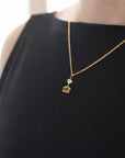 Herkimer diamond and lotus necklace in gold vermeil worn on a female model.