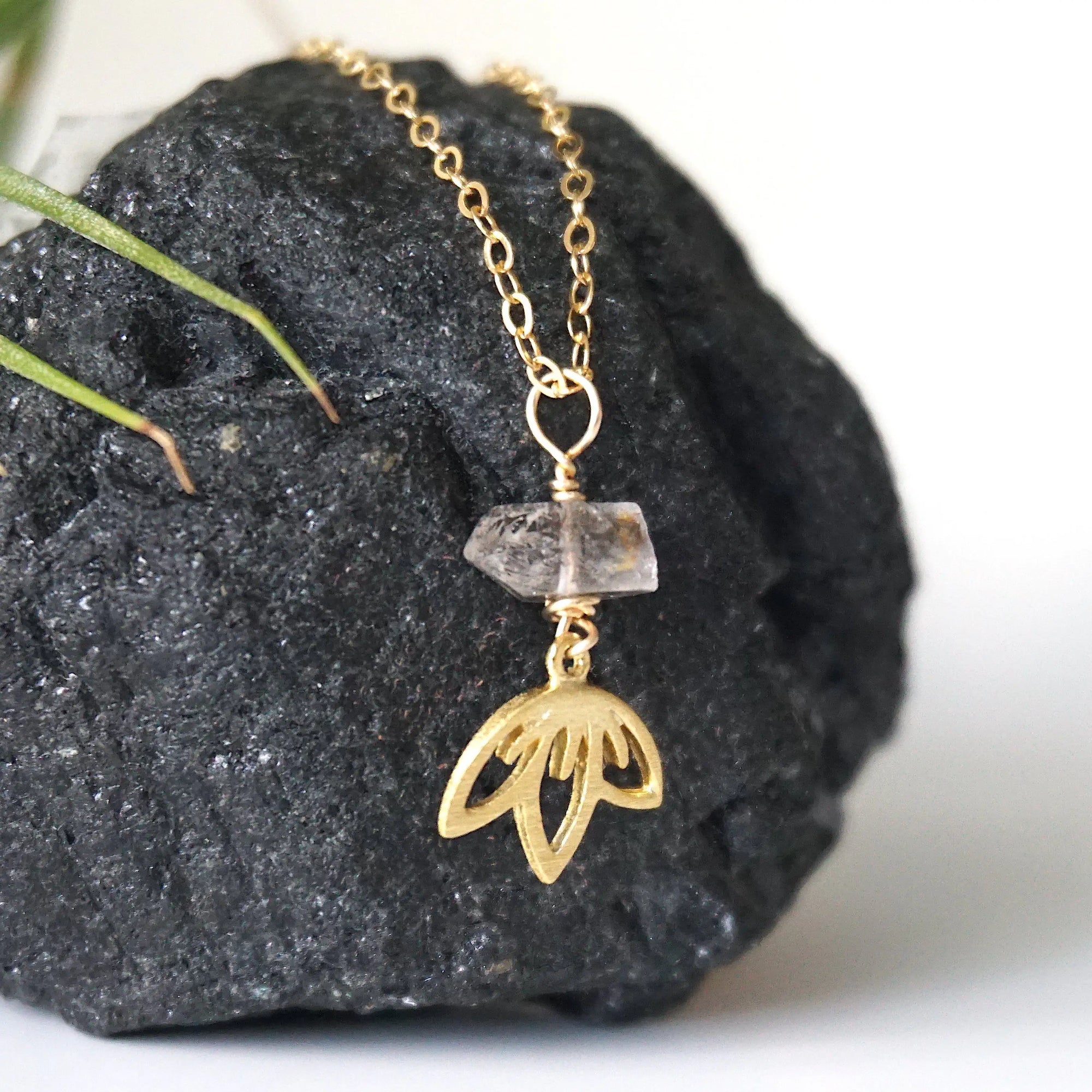 Right angle detail of Herkimer diamond and lotus necklace showing handcrafted artisan design.