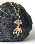 Right angle detail of Herkimer diamond and lotus necklace showing handcrafted artisan design.