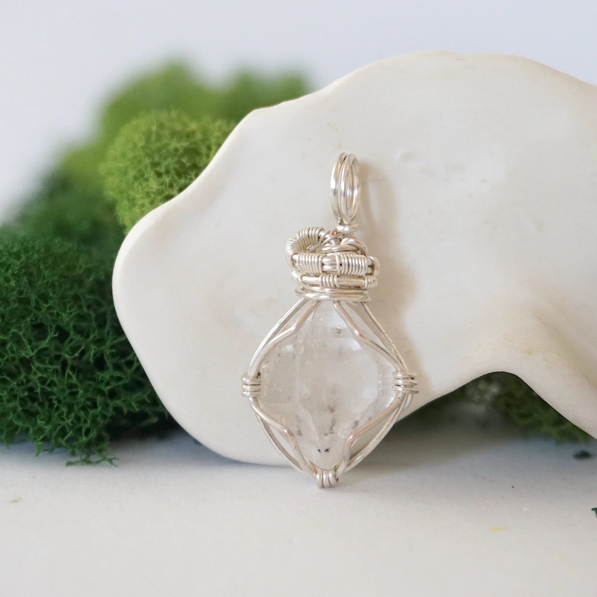 Front angle view of raw Herkimer diamond pendant in soft silver copper with detailed artisan wire wrapping.