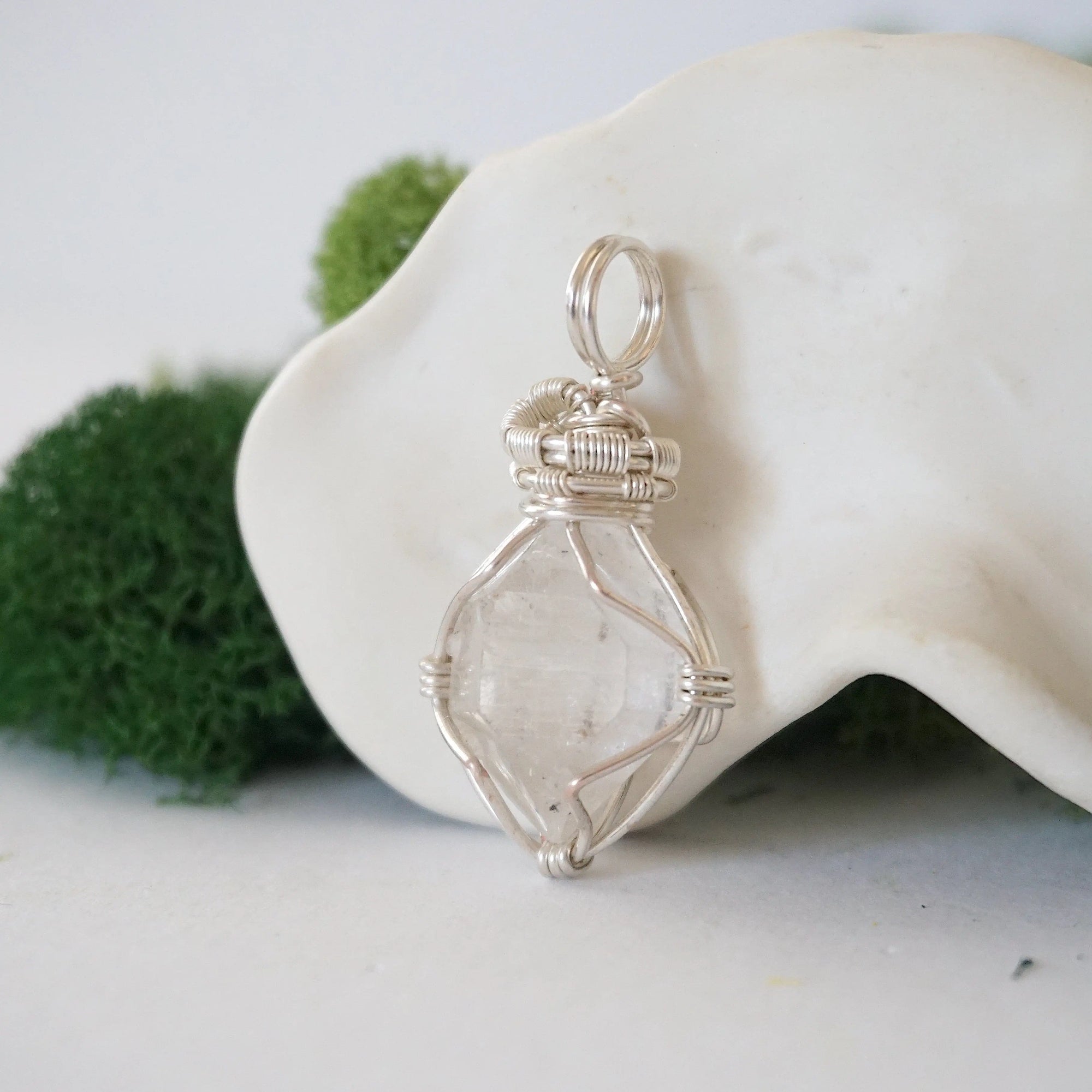 Left angle detail of handmade Herkimer diamond pendant highlighting soft silver copper wire artistry.