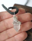 Raw Herkimer diamond pendant for men shown in hand for size reference, handmade in 925 sterling silver.