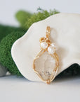 Detailed front angle of herkimer diamond and freshwater pearl pendant, gold wire wrapped, handcrafted gemstone jewelry