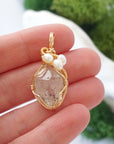 Herkimer diamond and freshwater pearl necklace pendant in hand for size reference, artisan birthstone jewelry gift for her