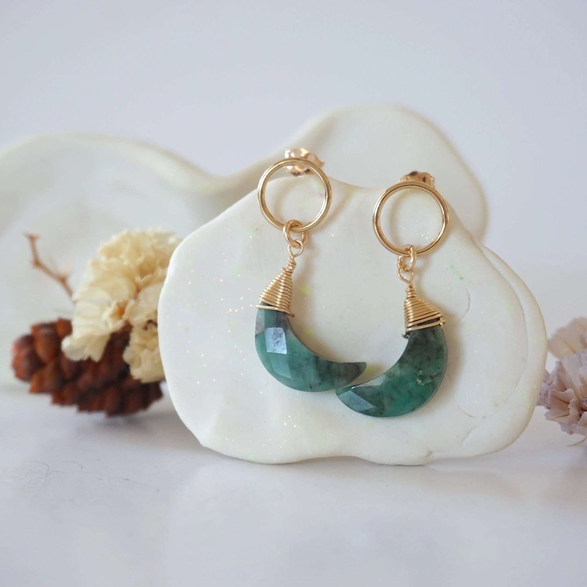 Detailed close-up of Lux Limited Edition Emerald Moon Open Circle Stud Earrings on jewelry display, faceted natural emerald, 14k gold filled, handmade.