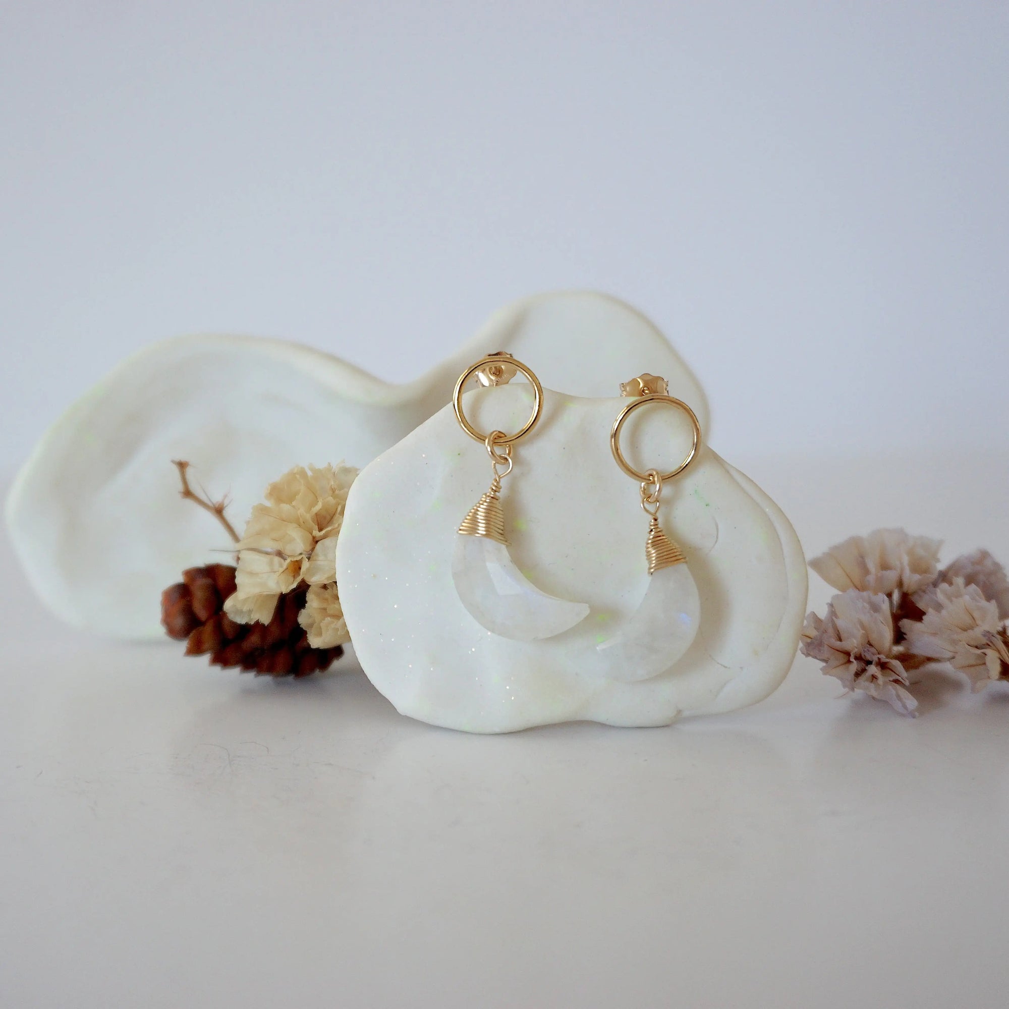 Front angle look at Lux Rainbow Moonstone Moon Open Circle Stud Earrings on jewelry display, faceted natural rainbow moonstone, gold filled, handmade.