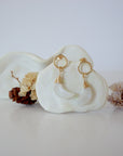 Front angle look at Lux Rainbow Moonstone Moon Open Circle Stud Earrings on jewelry display, faceted natural rainbow moonstone, gold filled, handmade.