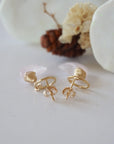 Detailed close-up of open circle stud earring closure, Lux Rose Quartz Moon Stud Earrings, 14k gold filled, handmade craftsmanship.