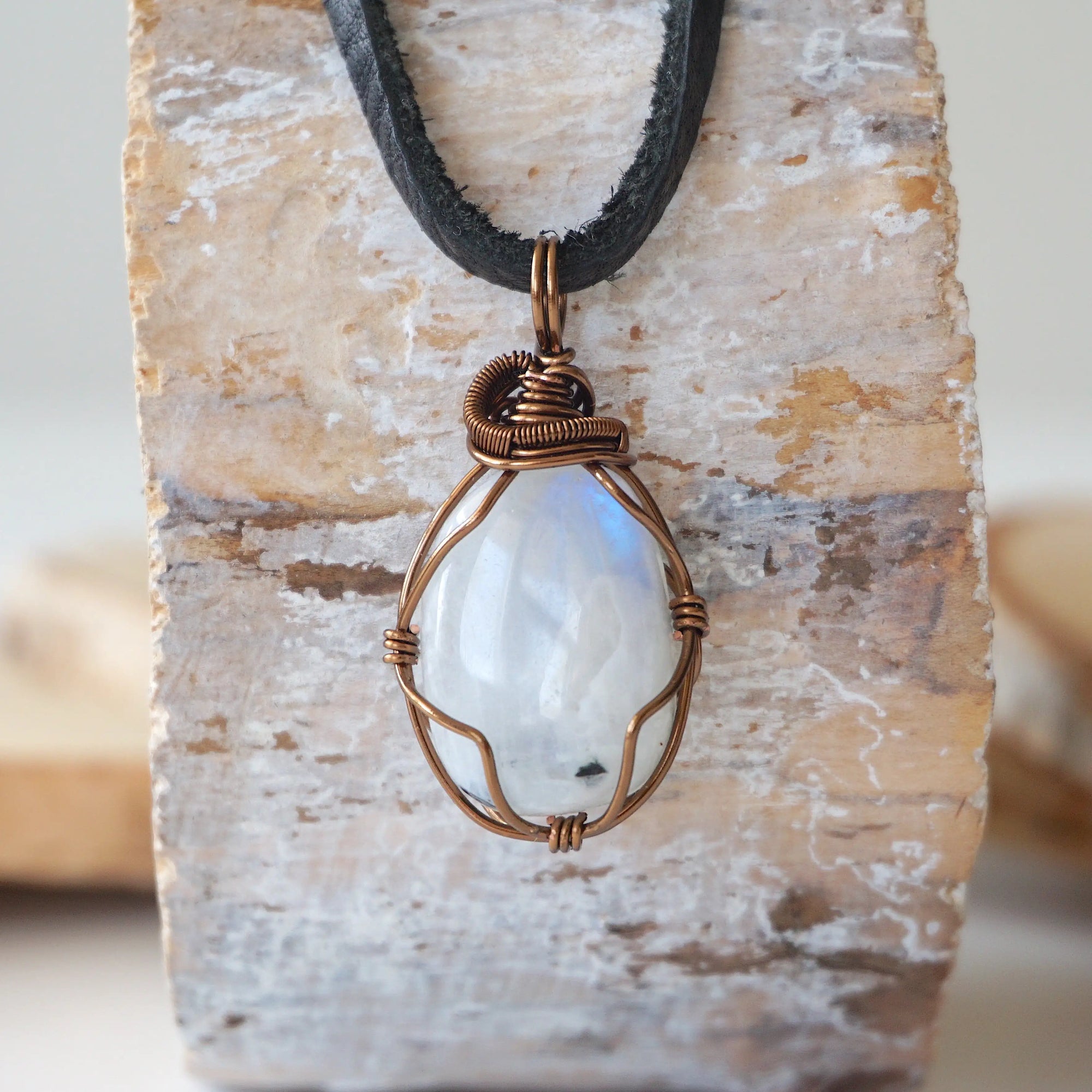 Men’s rainbow moonstone necklace with natural polished-raw pendant, antique bronze copper wire wrap and flat black leather cord