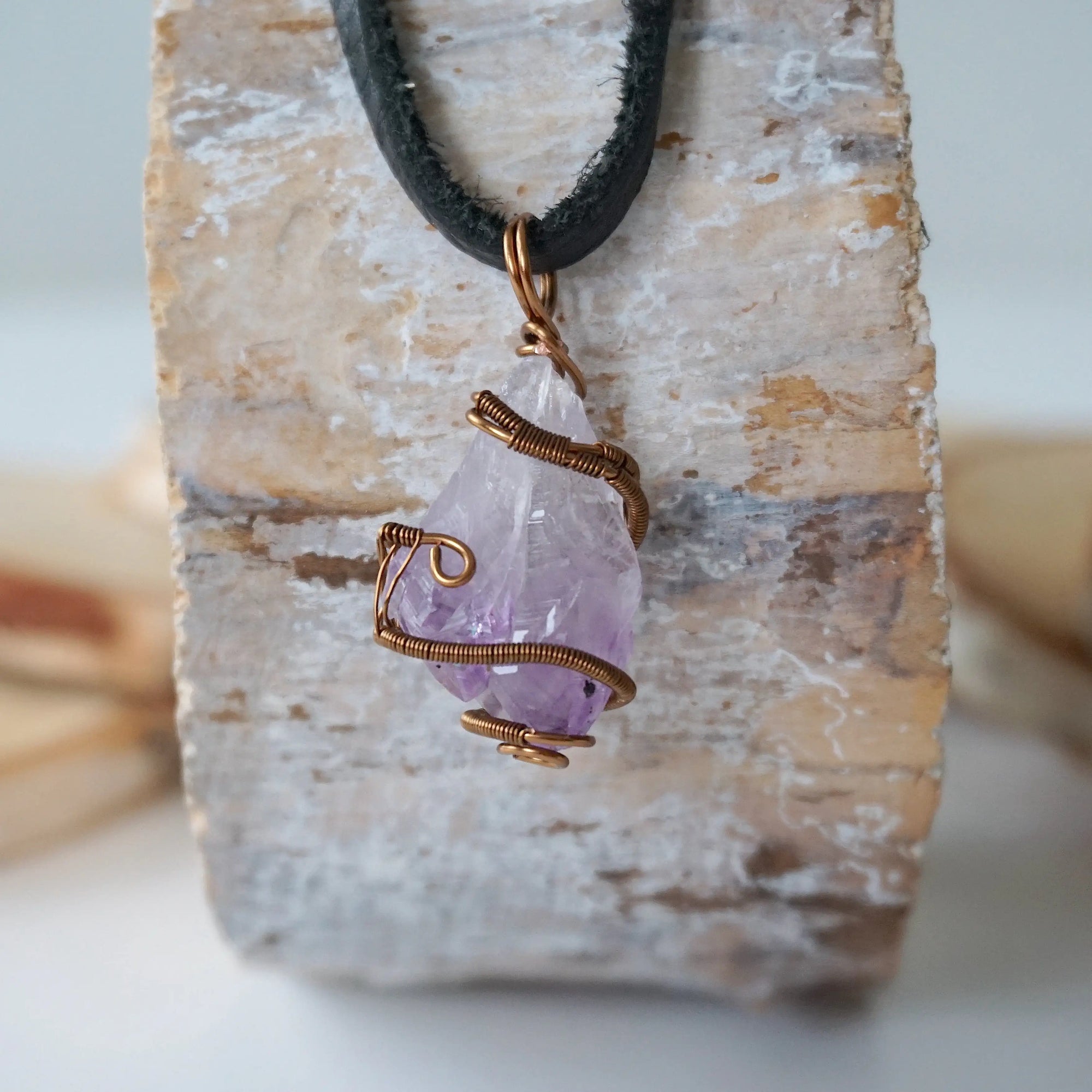 Back view of antique bronze copper wire wrapped raw amethyst pendant on black leather cord, men’s February birthstone necklace