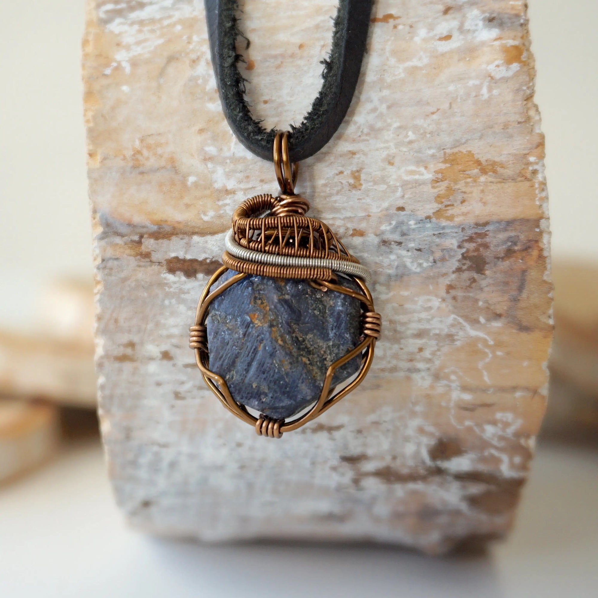 Men's raw sapphire necklace on a genuine black leather cord — antique bronze and dark silver wire wrap, handcrafted crystal jewelry by Designs by Nature Gems