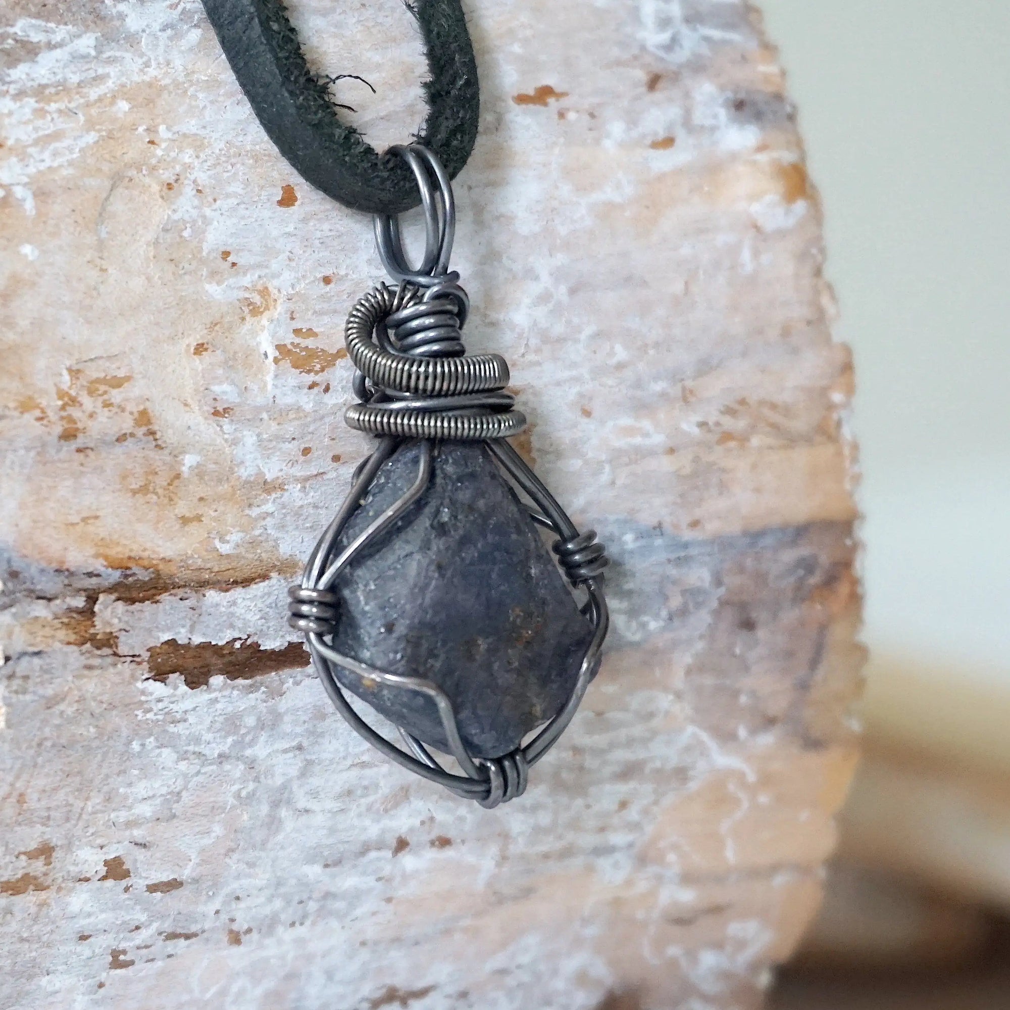 Right-angle detail of men's raw sapphire pendant showing artisan wire-wrapping in antiqued 925 sterling silver — handcrafted crystal necklace