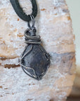 Right-angle detail of men's raw sapphire pendant showing artisan wire-wrapping in antiqued 925 sterling silver — handcrafted crystal necklace