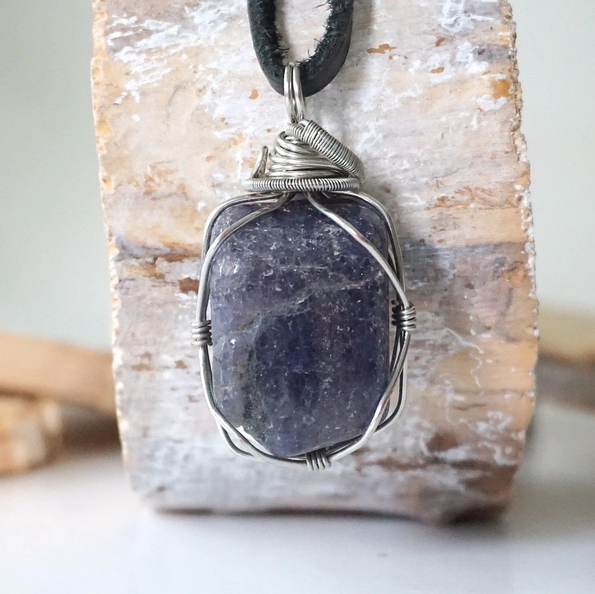 Back view of men's sapphire pendant showing the detail of dark silver wire-wrapping — one-of-a-kind handcrafted crystal jewelry by Designs by Nature Gems