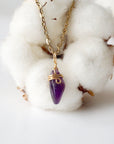 Detailed front view of minimalist amethyst necklace for women, raw amethyst pendant wire wrapped in gold plated copper