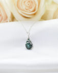 Minimalist emerald necklace for women with natural faceted teardrop emerald in 925 sterling silver, detailed front view