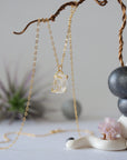 Side angle view of minimalist Herkimer diamond necklace showing gold vermeil prong setting detail.