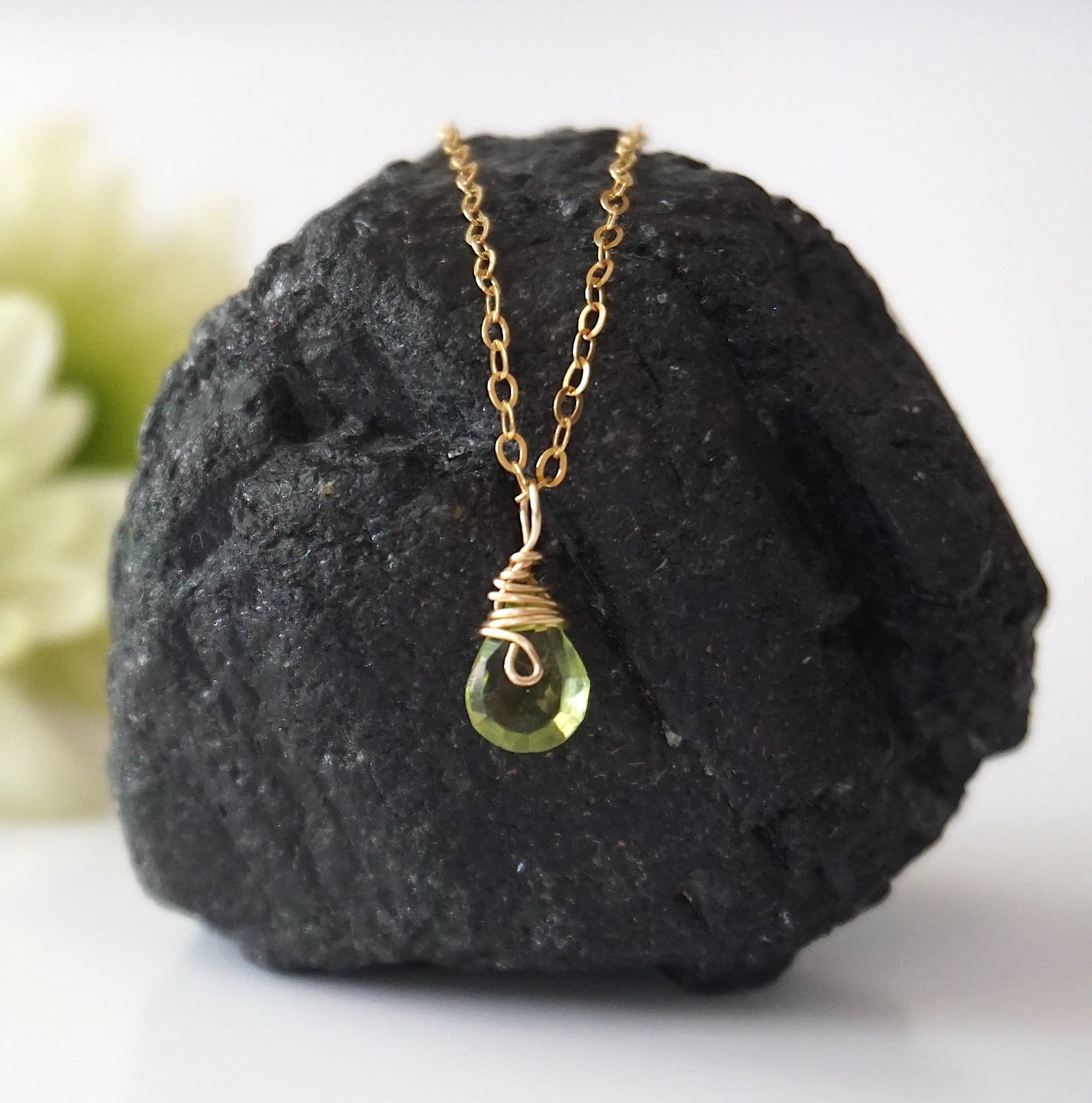 Front view of minimalist peridot pendant for women — faceted vivid lime green peridot with gold wire wrap bail, dainty 14k gold filled August birthstone necklace
