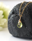 Left side detail of minimalist peridot pendant — 14k gold filled wire wrap and faceted natural peridot crystal, artisan dainty necklace for women, August birthstone jewelry