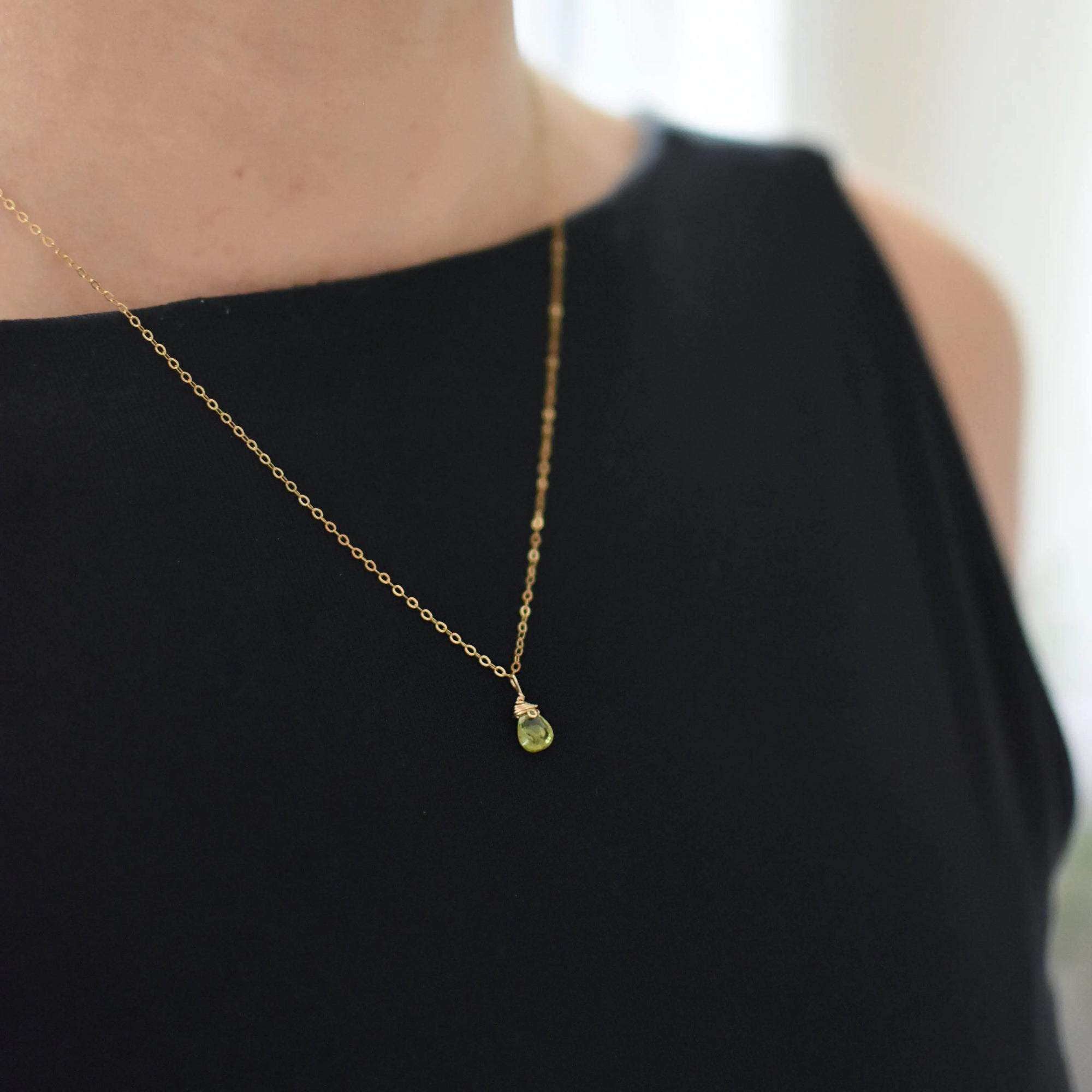Minimalist peridot necklace for women worn on model — dainty 14k gold filled chain with vivid lime green faceted peridot pendant, handmade August birthstone jewelry by Designs by Nature Gems