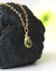 Right side detail of minimalist peridot pendant — 14k gold filled wire wrap bail, faceted natural peridot crystal, handcrafted dainty August birthstone necklace for women