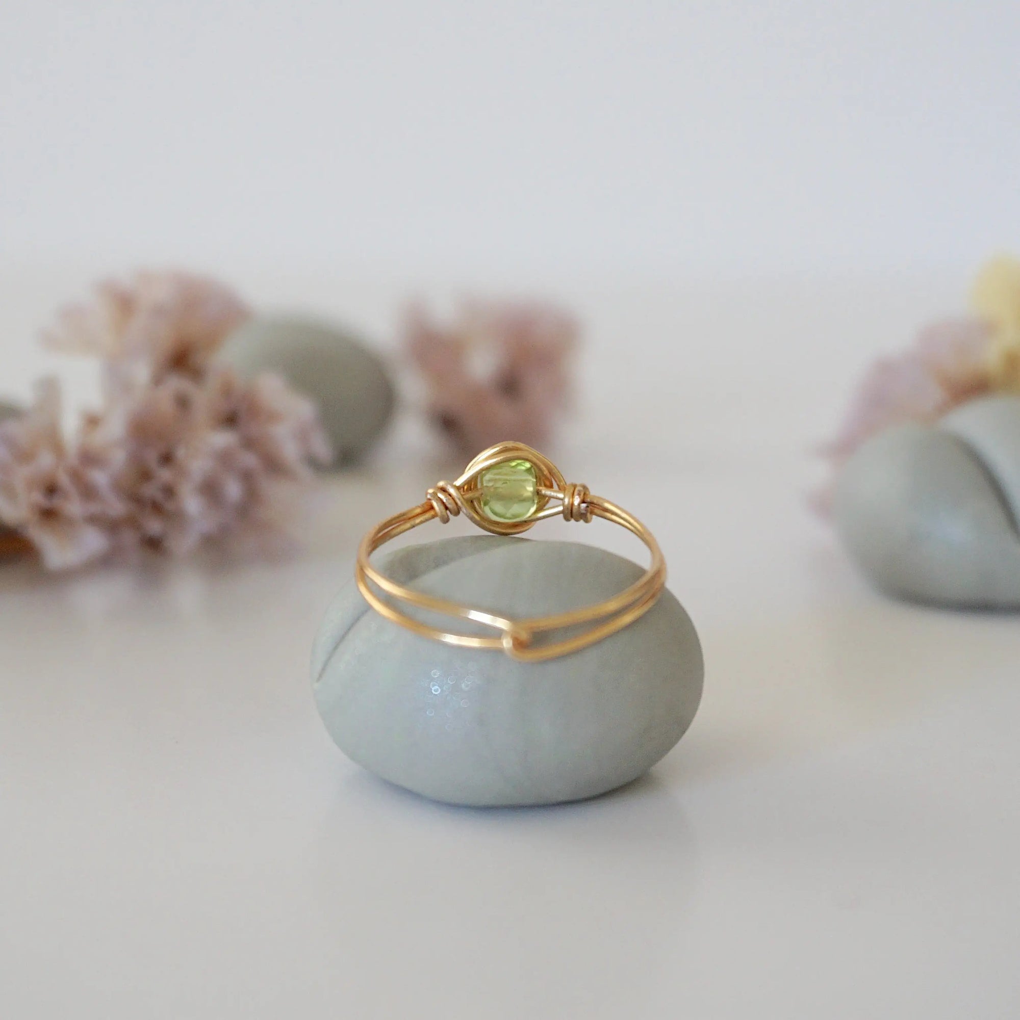 Back view of minimalist gold wire wrapped peridot ring — handcrafted wire band detail in warm gold finish, dainty August birthstone crystal ring for women by Designs by Nature Gems