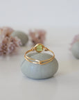 Back view of minimalist gold wire wrapped peridot ring — handcrafted wire band detail in warm gold finish, dainty August birthstone crystal ring for women by Designs by Nature Gems