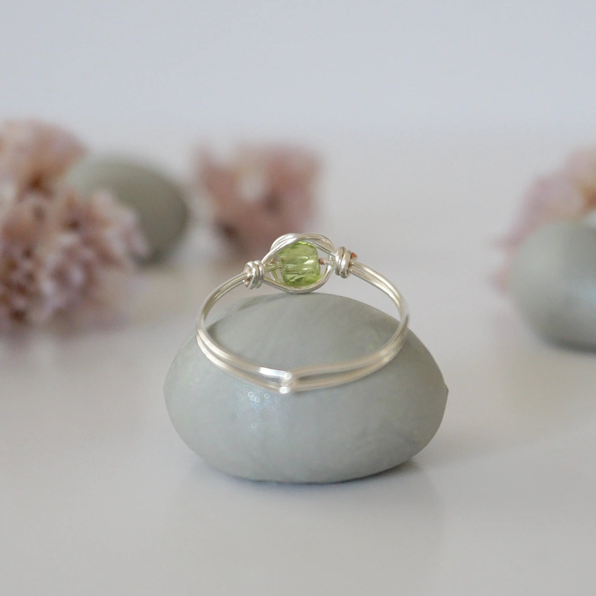 Back view of minimalist silver wire wrapped peridot ring — handcrafted wire band detail, dainty August birthstone crystal ring for women by Designs by Nature Gems