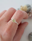 Minimalist peridot ring for women in silver finish — faceted olive green peridot bead wire wrapped on model's hand, dainty August birthstone crystal ring by Designs by Nature Gems