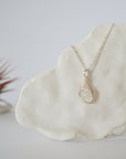 Close-up front view of minimalist rainbow moonstone necklace for women with natural 8mm moonstone bead in soft silver wire wrap (June birthstone).